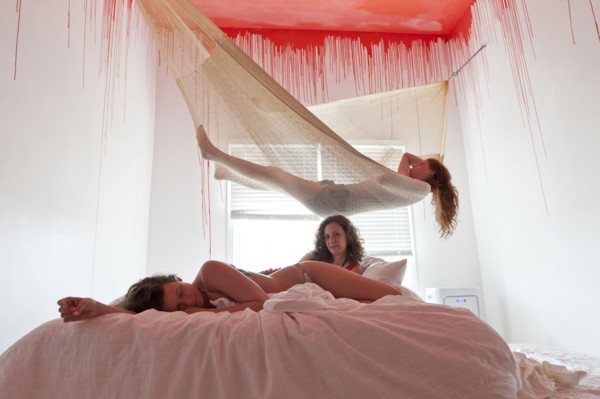 Women laying on bed and hammock under dripping ceiling
