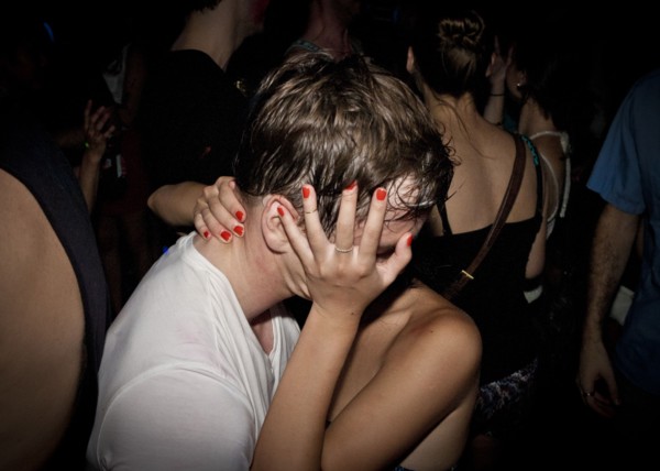 Close up of couple kissing at party