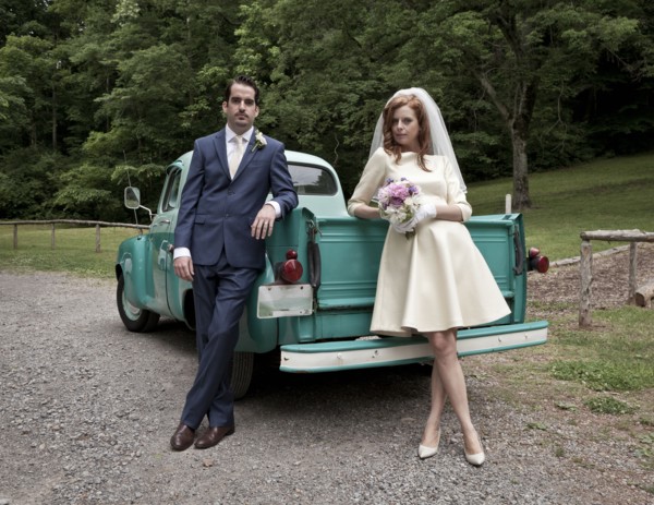 Bride and groom smiling near vintage truck