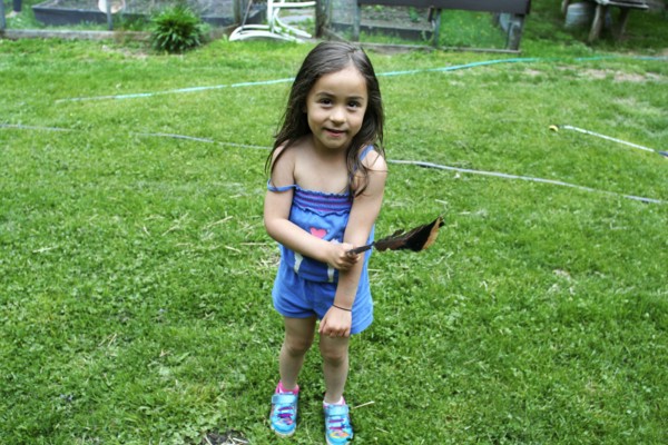 Caucasian girl playing in backyard