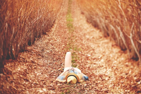 Caucasian woman laying on dirt path