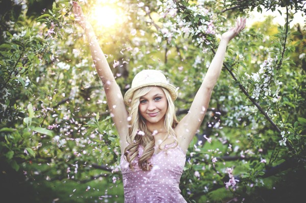 Woman standing in flowering trees