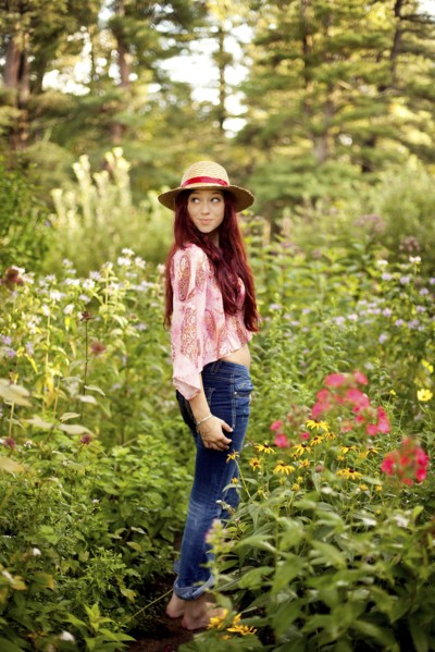 Girl wearing straw hat in garden