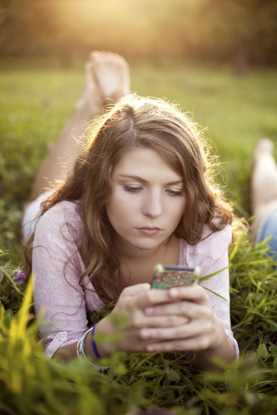 Woman using cell phone in rural field
