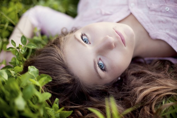 Close up of woman laying in grass