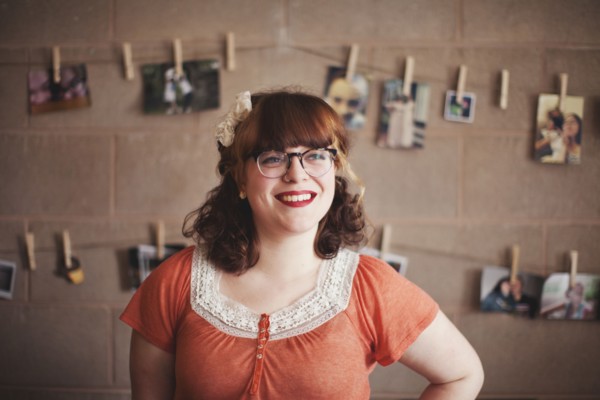 Caucasian photographer standing near hanging photographs