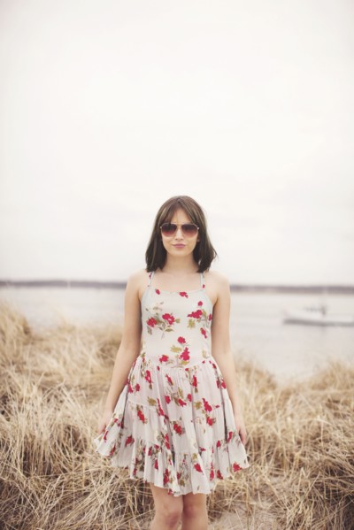Caucasian woman standing in beach grass