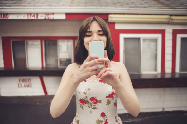 Caucasian woman taking selfie with cell phone