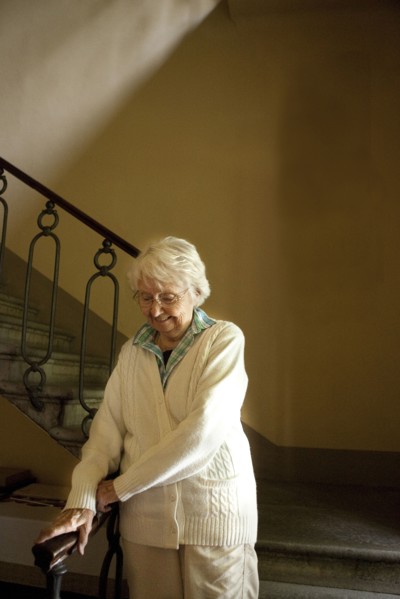 Older Caucasian woman climbing stairs