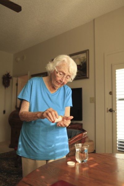 Older Caucasian woman taking medication