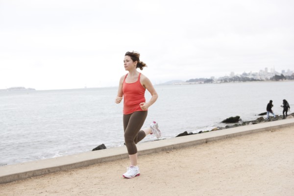 Caucasian woman running on waterfront