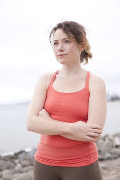 Caucasian woman standing on rocky beach