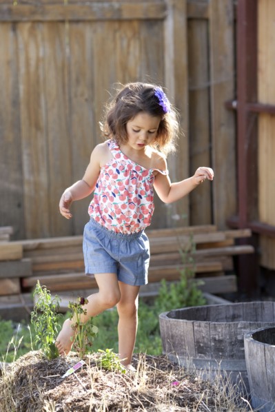 Mixed race girl playing in backyard