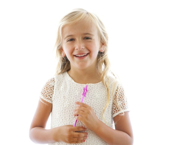 Smiling Caucasian girl holding fairy wand