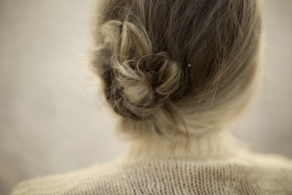 Close up of woman wearing bun and sweater