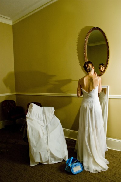 Bride adjusting makeup in mirror