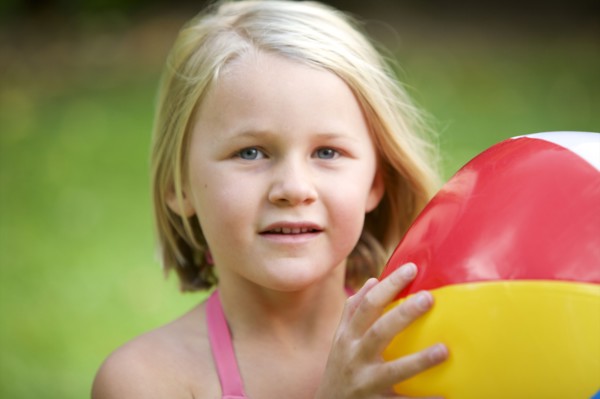 Close up of girl holding beach ball