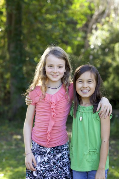 Smiling girls hugging in backyard