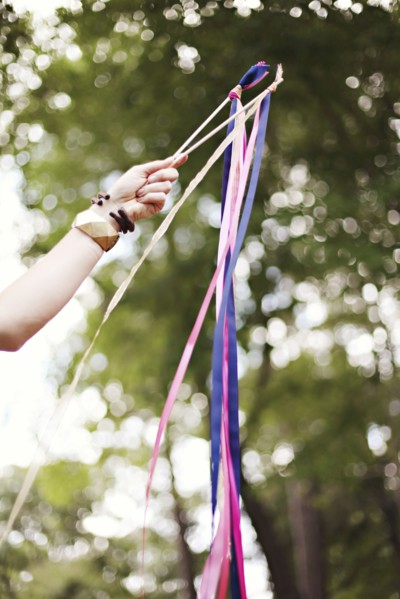 Low angle view of girl playing with ribbons outdoors