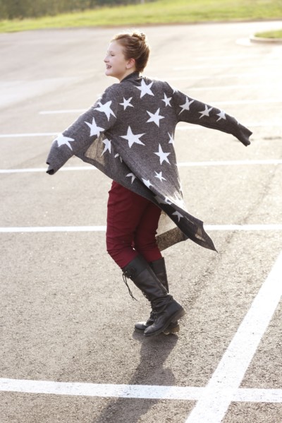Stylish Caucasian girl walking in parking lot