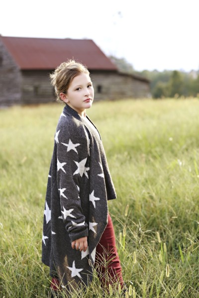Stylish Caucasian girl walking in rural field