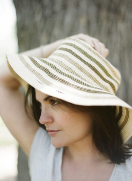 Close up of serious woman wearing sun hat