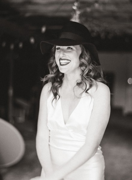 Smiling woman wearing sun hat in backyard
