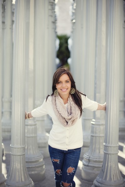 Smiling woman playing in columns