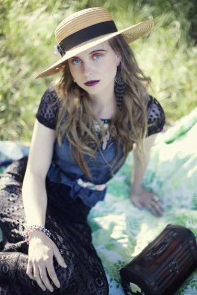 Stylish woman sitting on blanket