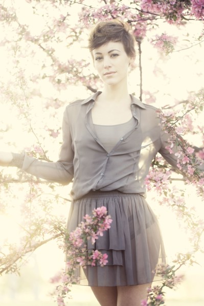 Woman standing in flowering trees