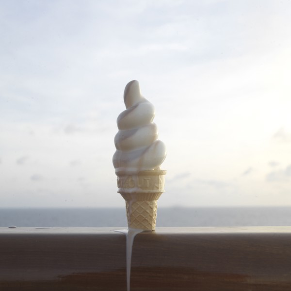 Close up of melting ice cream cone on banister