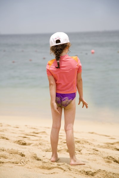 Caucasian girl walking on beach