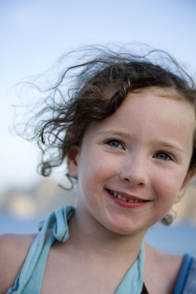 Close up of Caucasian girl smiling outdoors