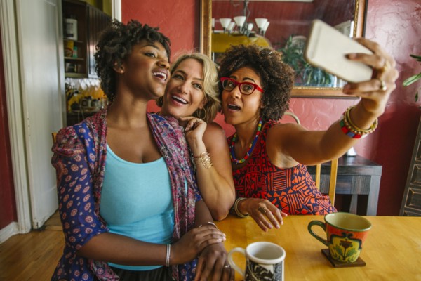 Smiling women taking selfie