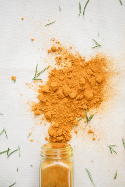 Jar of spilled spices and herbs