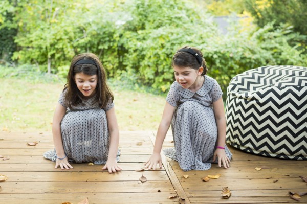 Twin sisters playing on deck