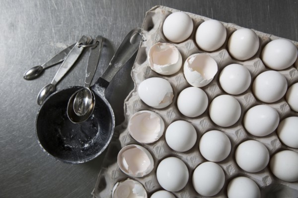 Carton of eggs with measuring spoons