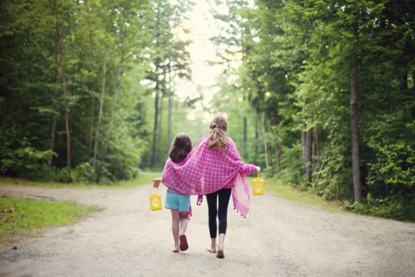 Caucasian sisters walking on dirt road