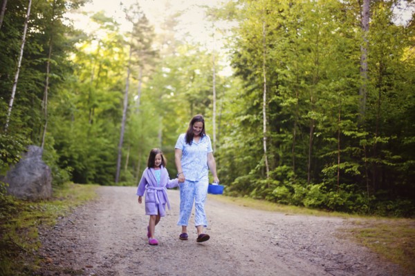 Caucasian mother and daughter walking on dirt road