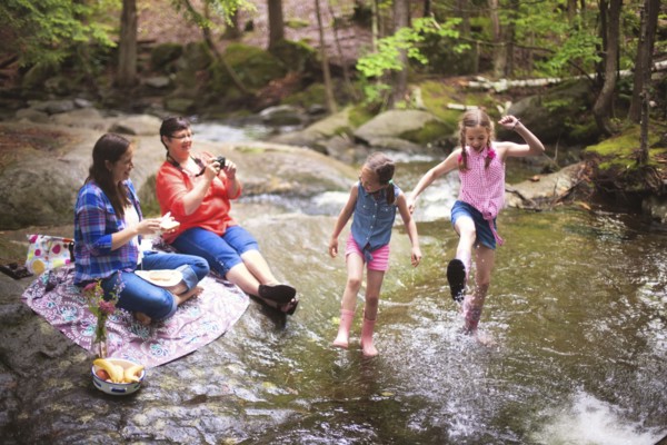 Three generations of Caucasian women playing in river
