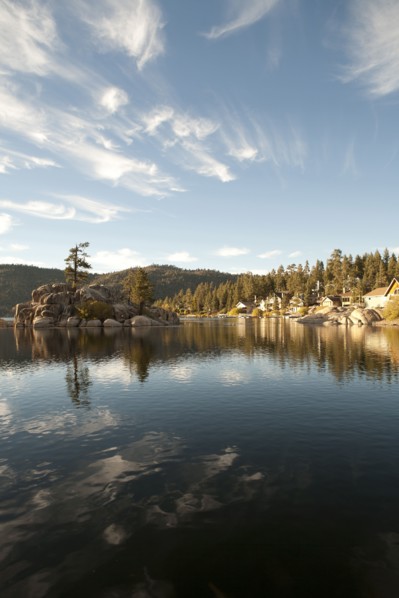 Blue sky and hills reflecting in remote lake