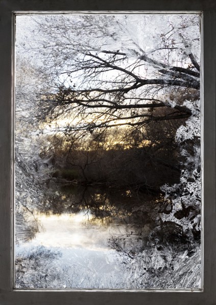 Frosty window and view of rural lake