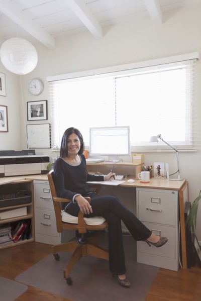 Hispanic woman working in home office