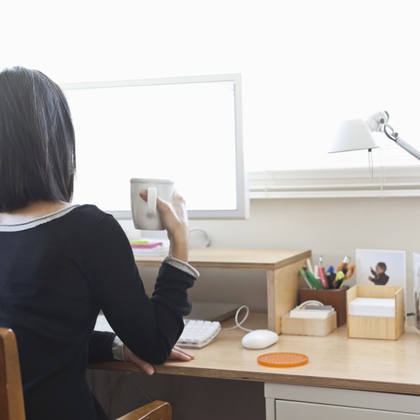 Hispanic woman working in home office