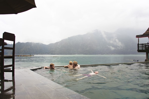 Caucasian children admiring scenic view from swimming pool