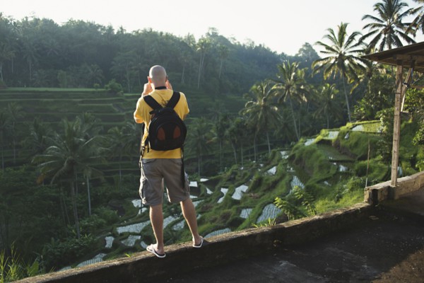 Caucasian tourist photographing rural rice terrace