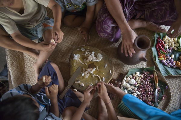Asian family eating on woven mat