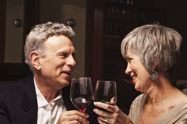 Couple toasting with red wine in restaurant