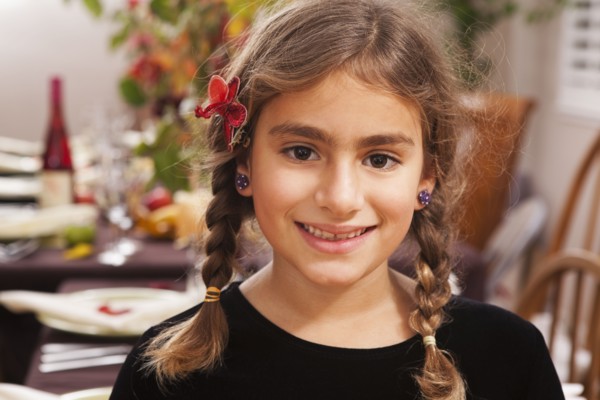 Smiling Hispanic girl at Thanksgiving dinner