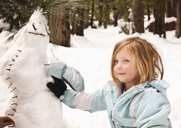 Caucasian girl making strange snowman